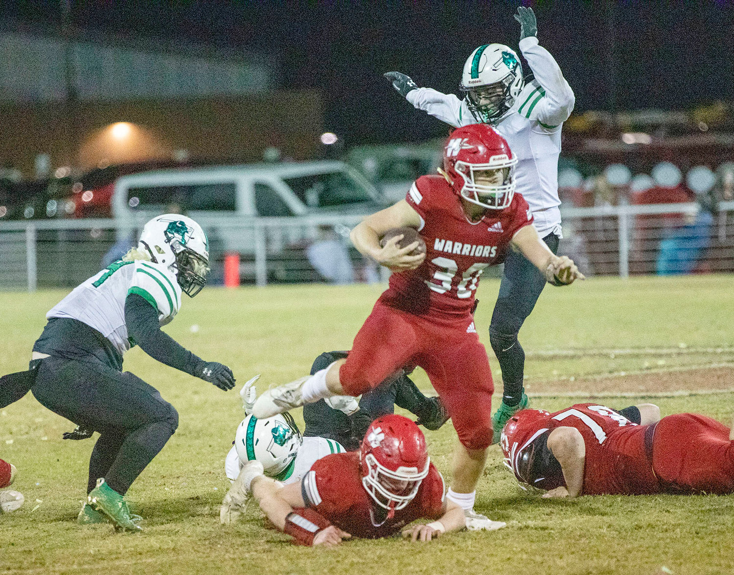 Washington sophomore Kade Norman rumbles over the line of scrimmage during the Warriors’ 52-21 win over Jones Friday night. Washington travels to Owasso to face Rejoice Christian in the quarterfinals of the State playoffs this Friday. Norman scored four touchdowns in the game.