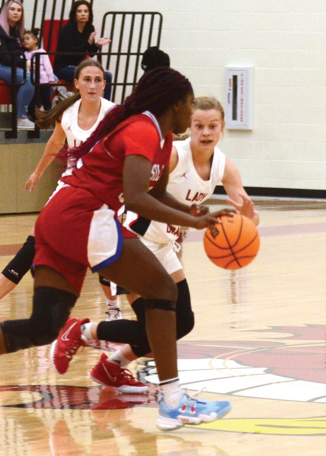 Purcell freshman Hadleigh Harp defends against the dribble during the Dragons’ 46-43 win Friday night.