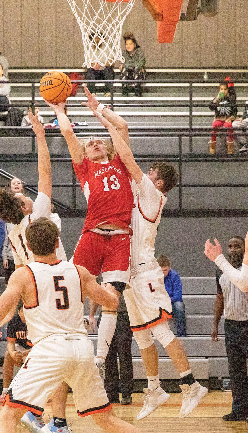 Washington senior Luke Hendrix goes up for two points against Lexington during the Warriors’ 60-47 win. Hendrix scored a team-high 13 points. See story on page 3B.