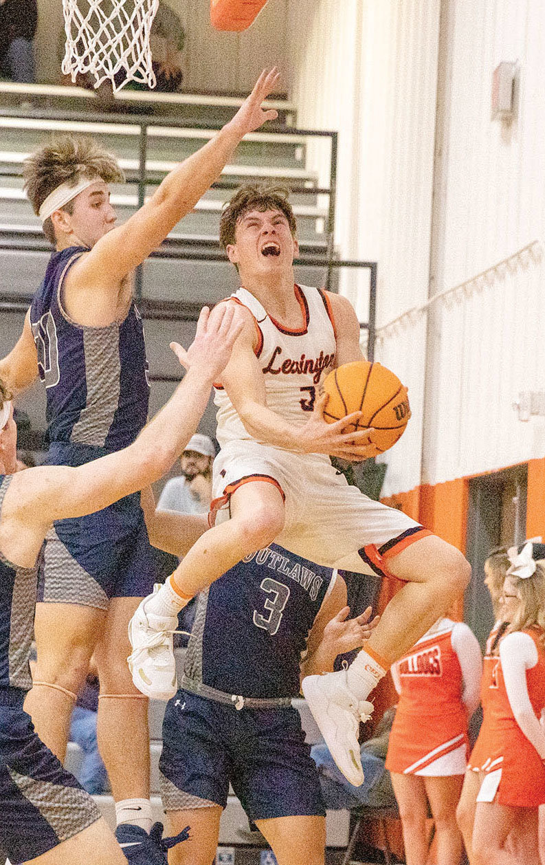 Lexington senior Heath Winterton hangs in the air while attempting a layup against Marlow. The Bulldogs were defeated 52-32. Winterton scored three points.