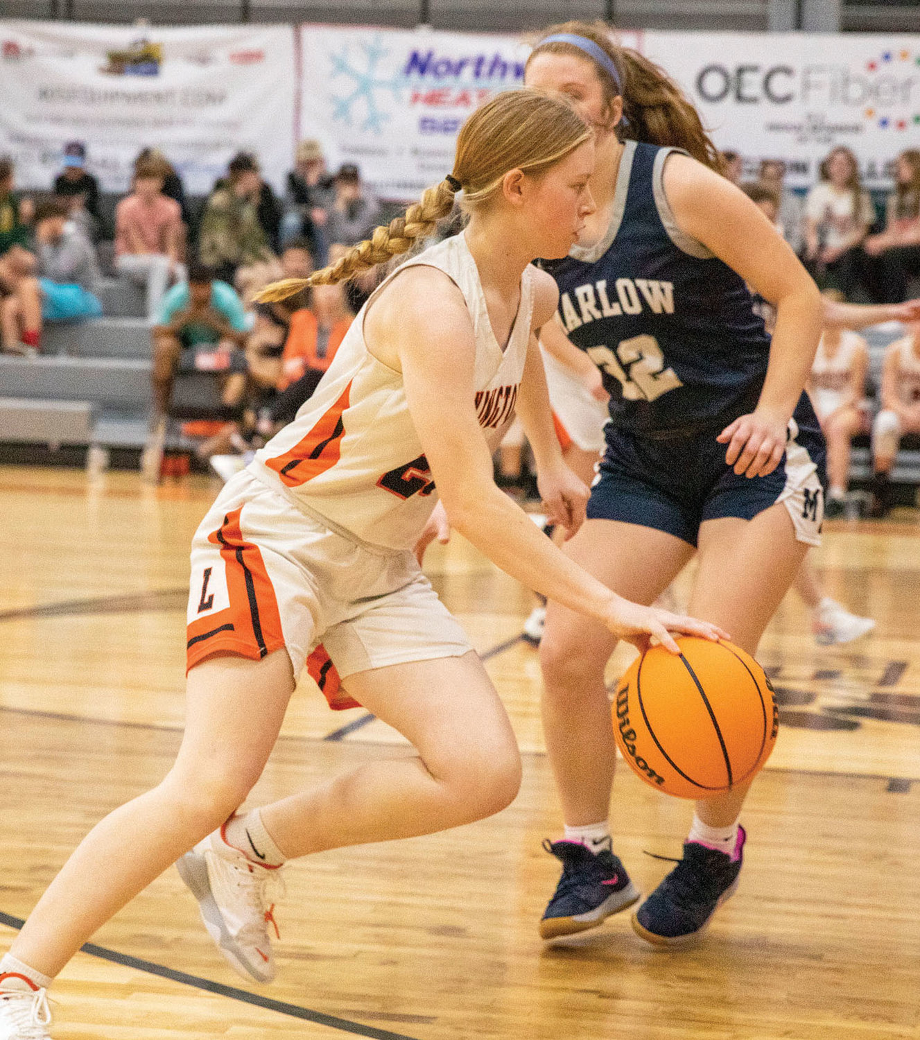 Lexington sophomore Abby Sample drives the ball against Marlow during their District matchup. The Bulldogs were defeated 52-32. Sample scored five points.