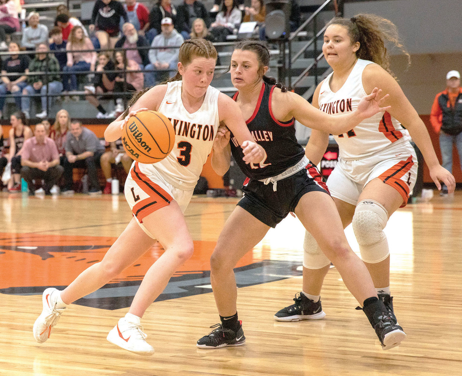 Lexington junior Rylee Beason (3) dribbles by a Pauls Valley defender while sophomore Kiely Givens (44) looks on. Lexington plays at Prague Friday at 6:30 p.m. in the District tournament.