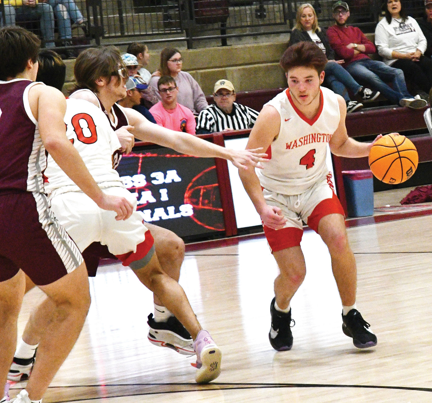 Washington senior Jamison Holland finds room during the Warriors’ 63-61 win over Perry in the Regional basketball tournament. Holland scored two points in the win.