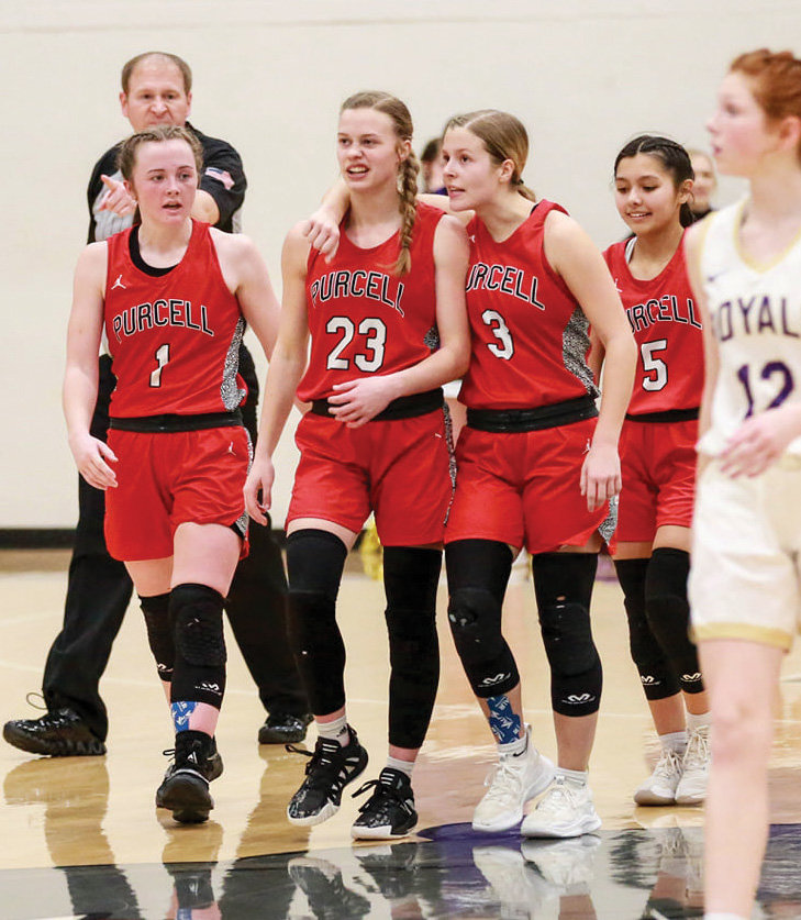 Lauren Holmes (1), Hadleigh Harp (23), KK Eck (3) and Kenna Esparza (5) enjoy a moment during Purcell’s 68-65 overtime win over CCS in the Regional tournament.