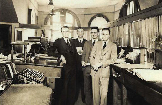 Earl Sherman, left, and his brother Neil, second from right, both joined the staff at McClain County National Bank in the 1930s. Both men would go on to serve as president and chairman of the board. Pictured with them are V.V. Haney, between the brothers, and Almer Ellison.