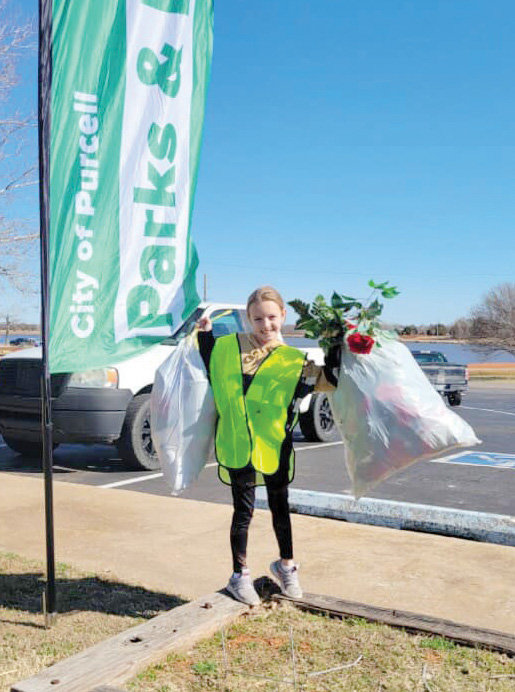 This young volunteer did her part cleaning up the area around Purcell Lake on Saturday.