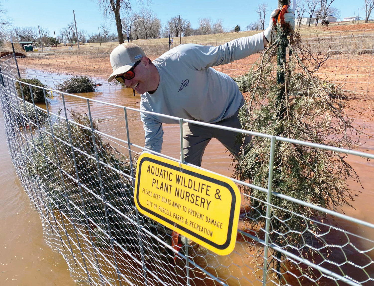 The Oklahoma Department of Wildlife Conservation cut nuisance cedar trees and used them to build new aquatic habitat for fish and wildlife at Purcell Lake.