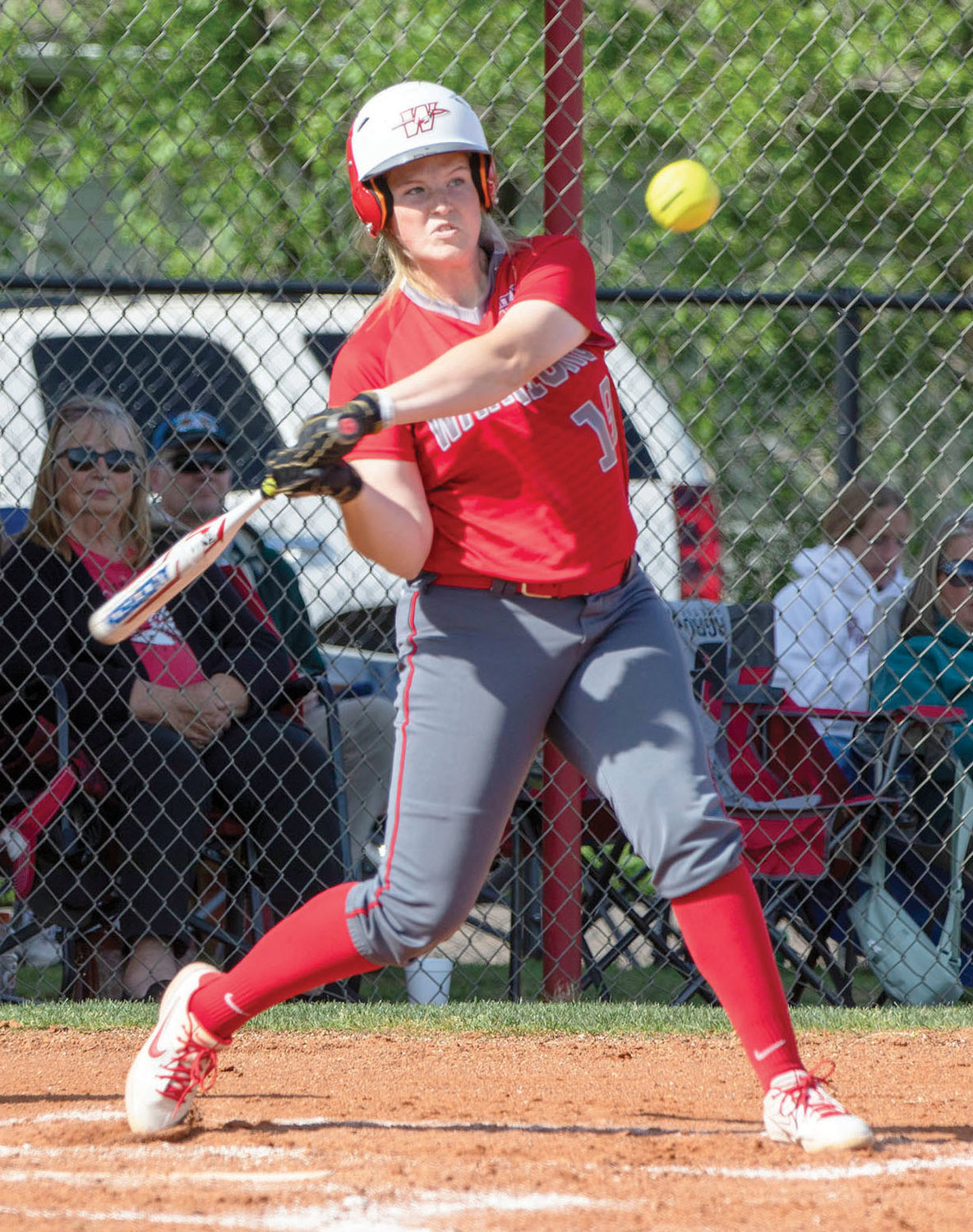 Washington junior Maggie Place pounds a ball during the Warriors’ 11-3 win over Plainview. Place hit two home runs in the game.