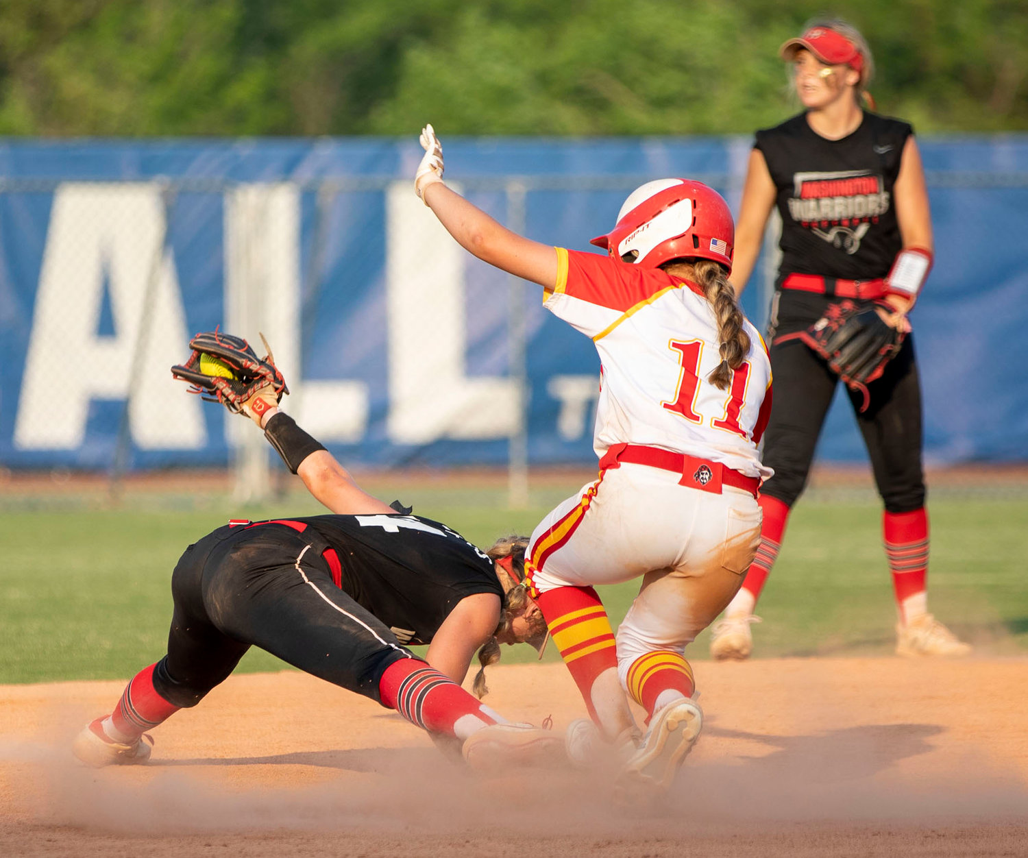 Washington junior Ellie Loveless stretches for every inch as she catches a ball at second base against Dale in the finals of the State tournament. Washington won 17-7.