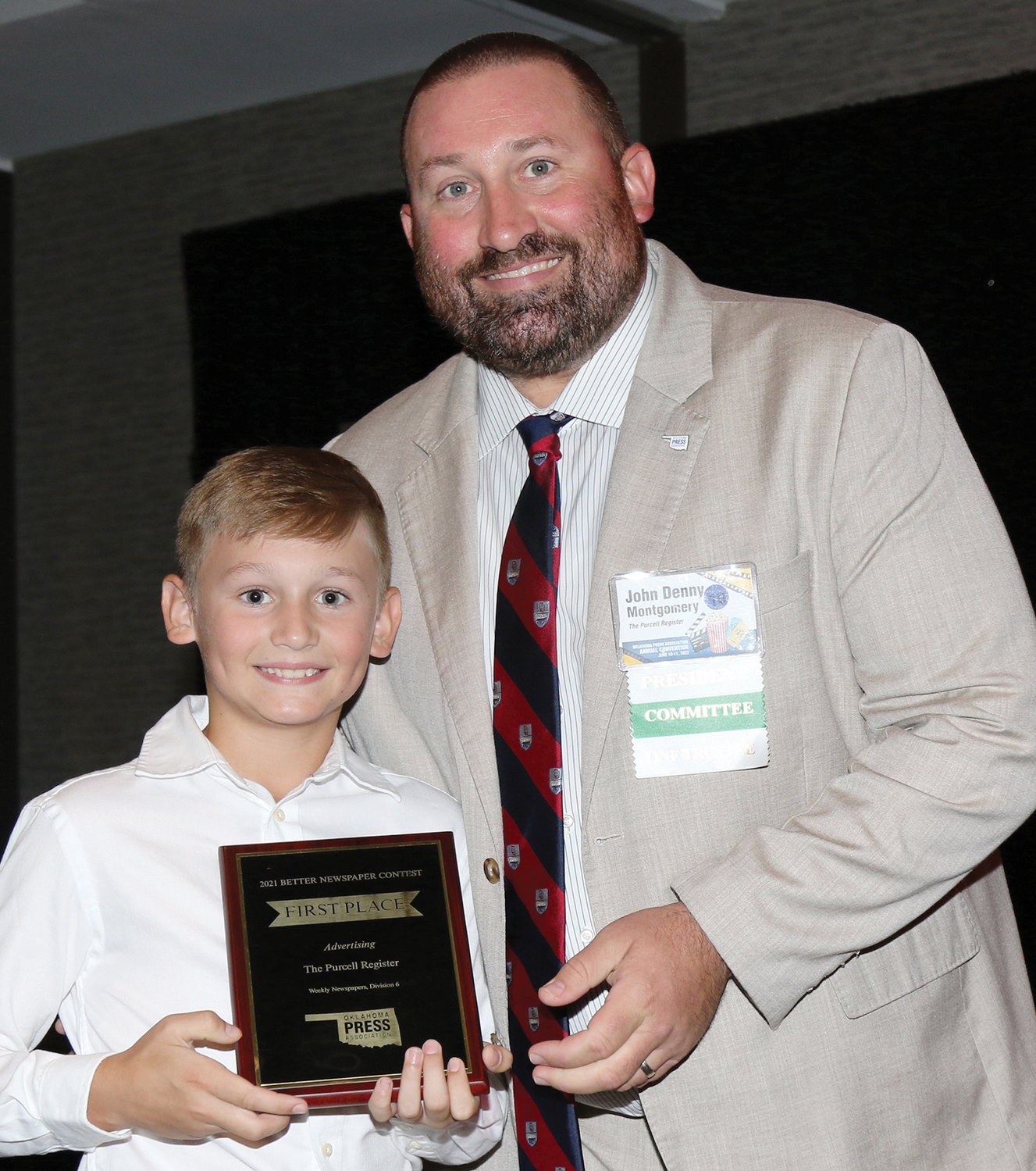 Jack Montgomery accepted a first place plaque on behalf of The Register in the 2021 Oklahoma Press Association Better Newspaper Contest from his father and OPA President John Denny Montgomery at the Sheraton Oklahoma City Downtown Hotel last Saturday night.