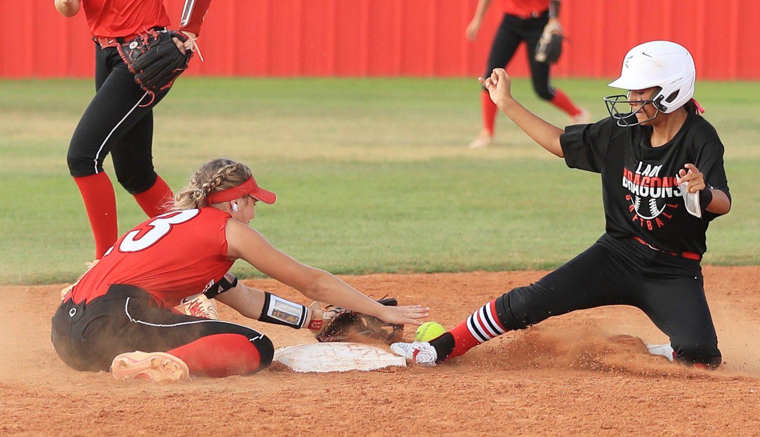 Purcell sophomore Kenna Esparza (right) narrowly steals second base before Washington senior Ellie Loveless can apply the tag. The Warriors defeated the Dragons 6-0.