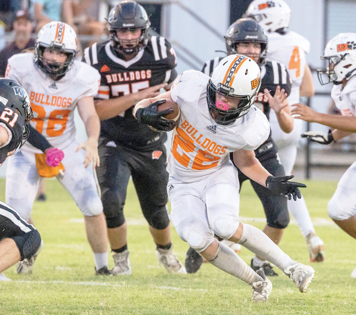 Lexington sophomore Dalton Brewer (22) puts a move on a Wayne defender while carrying the ball Friday night. Lexington was defeated 55-16. Brewer had one of Lexington’s two scores when he took the ball 16 yards to the house in the 1st quarter.