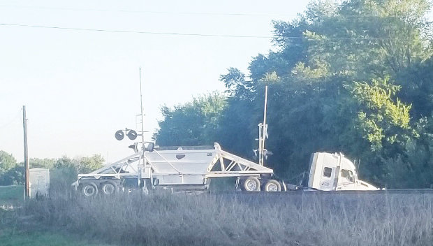 A truck transporting rock got stuck on the railroad crossing at 170th and U.S. 77 early Monday morning. Trains were halted until the vehicle could be removed.