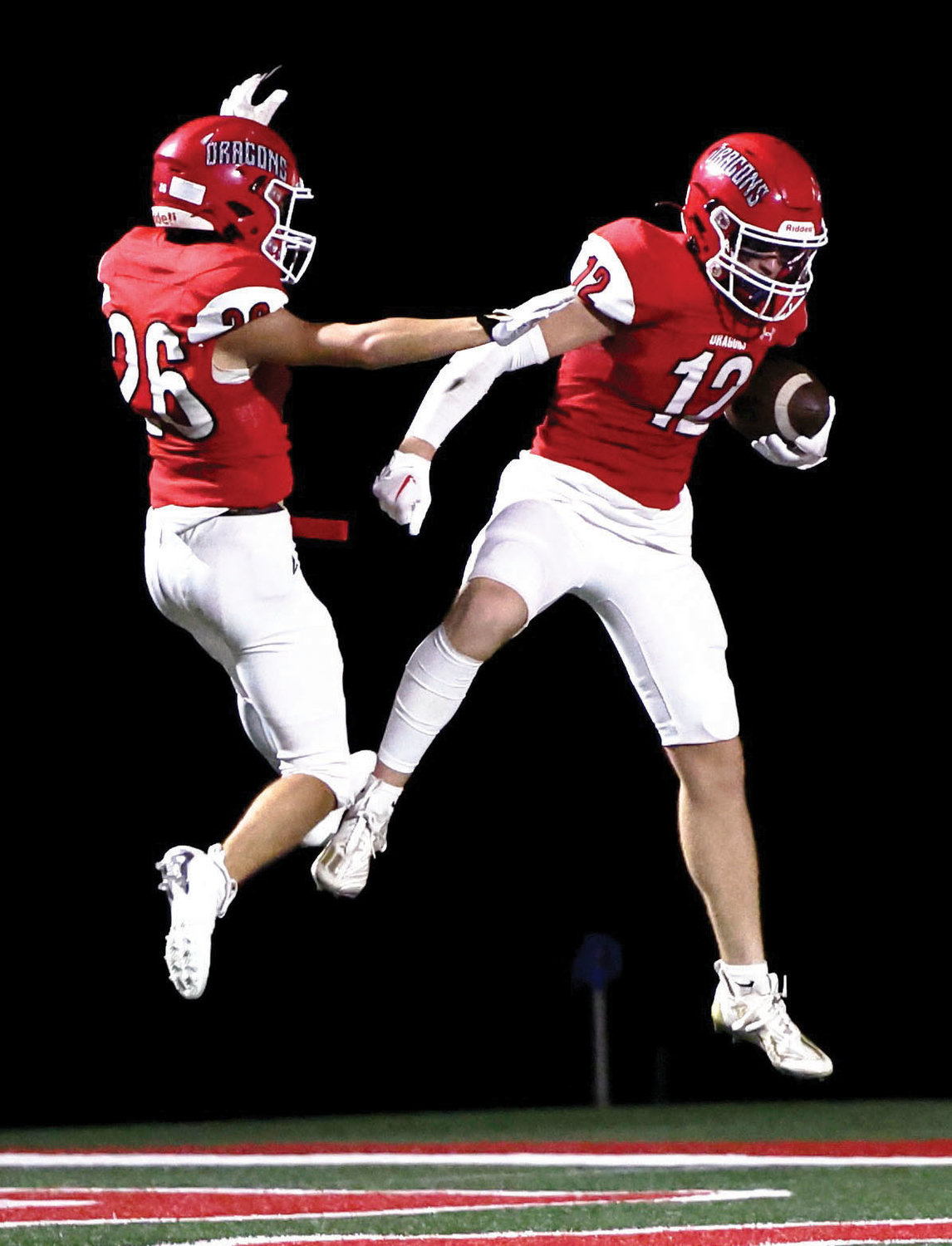 Purcell senior Lincoln Eubank (12) celebrates a touchdown with teammate Jett Tyler (26) during the Dragons’ 58-7 win over Crooked Oak. Eubank had two touchdown receptions for a total of 87 yards receiving.