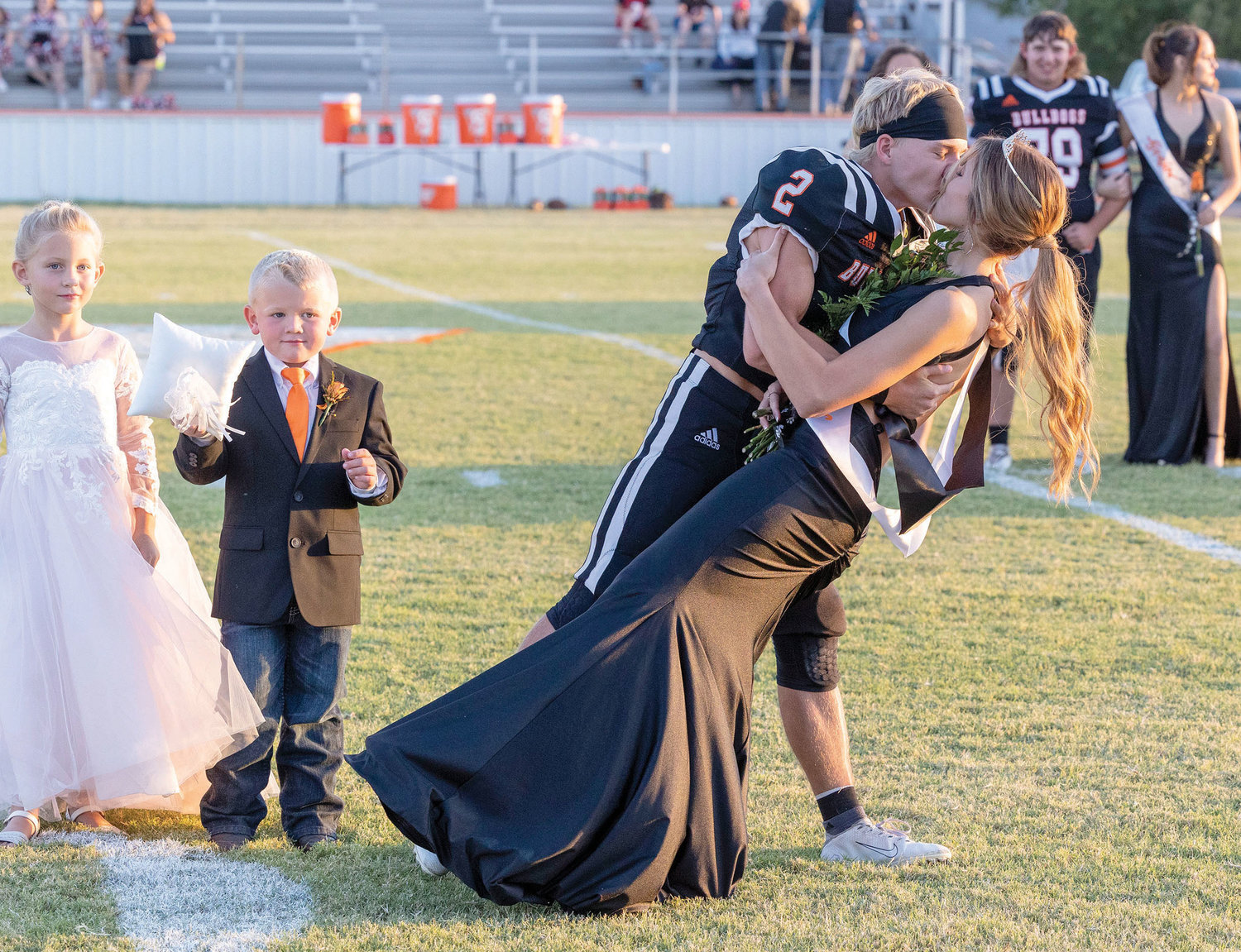 King Rhett Kennedy and Queen Mikaela Hickman punctuated their coronation with a kiss last Friday night during Wayne’s Homecoming ceremony. Flower girl Swayze Sharp and crown bearer Rhett Boles look on.
