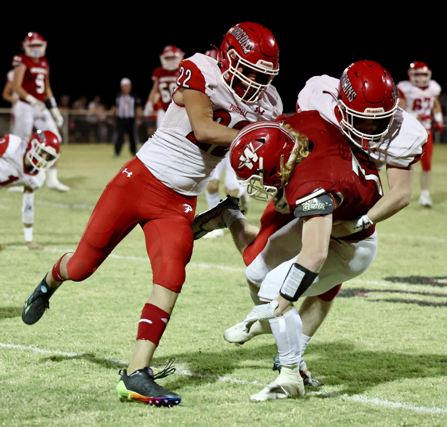 Payson Purcell (22) and Adam Edelman (73) tackle Washington’s Cole Scott. The Dragons host Little Axe Friday night at Conger Field.