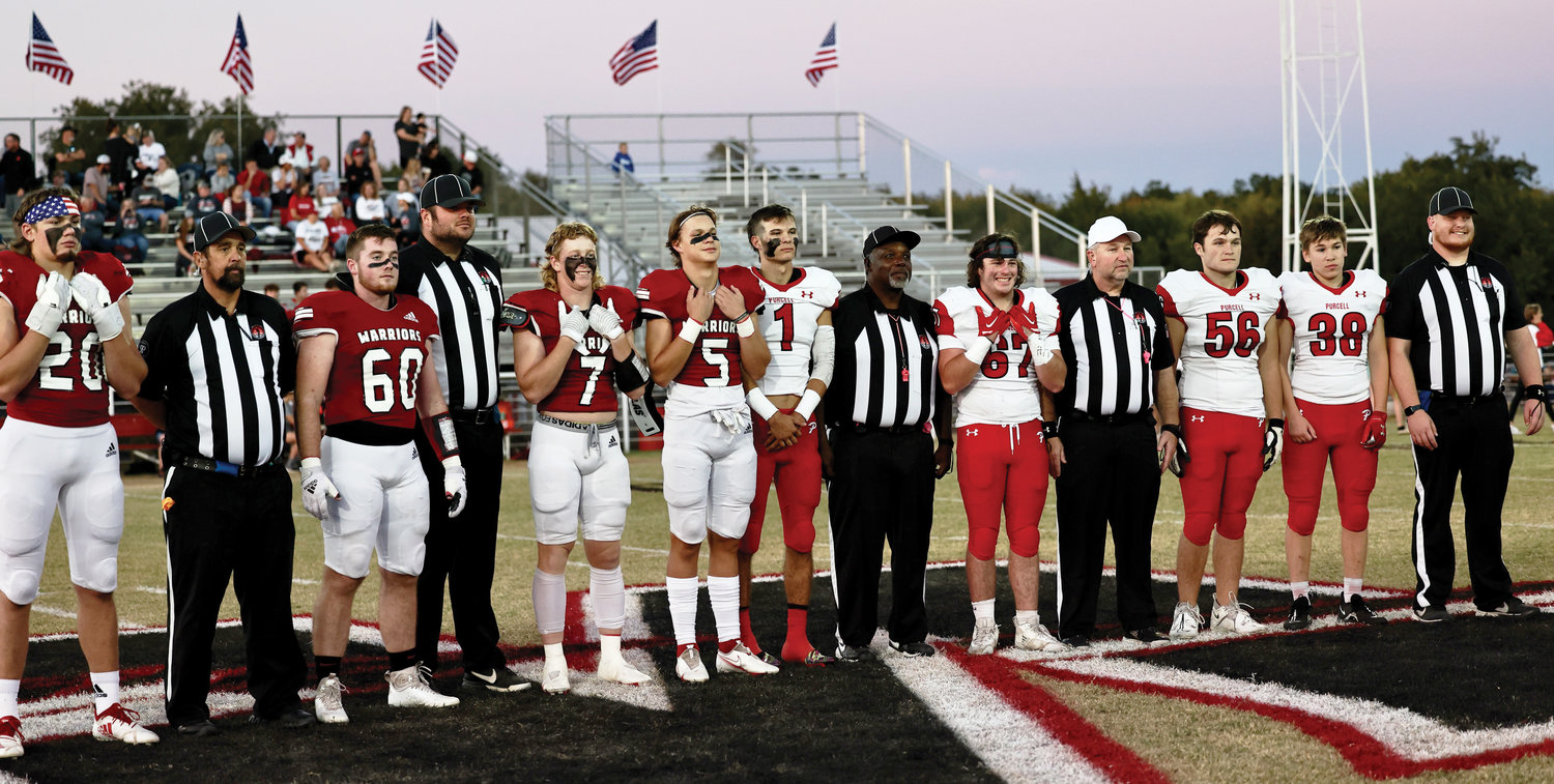 Team captains from the Washington Warriors and the Purcell Dragons lined up with the game officials before last Friday night’s contest in honor of Official Appreciation night.