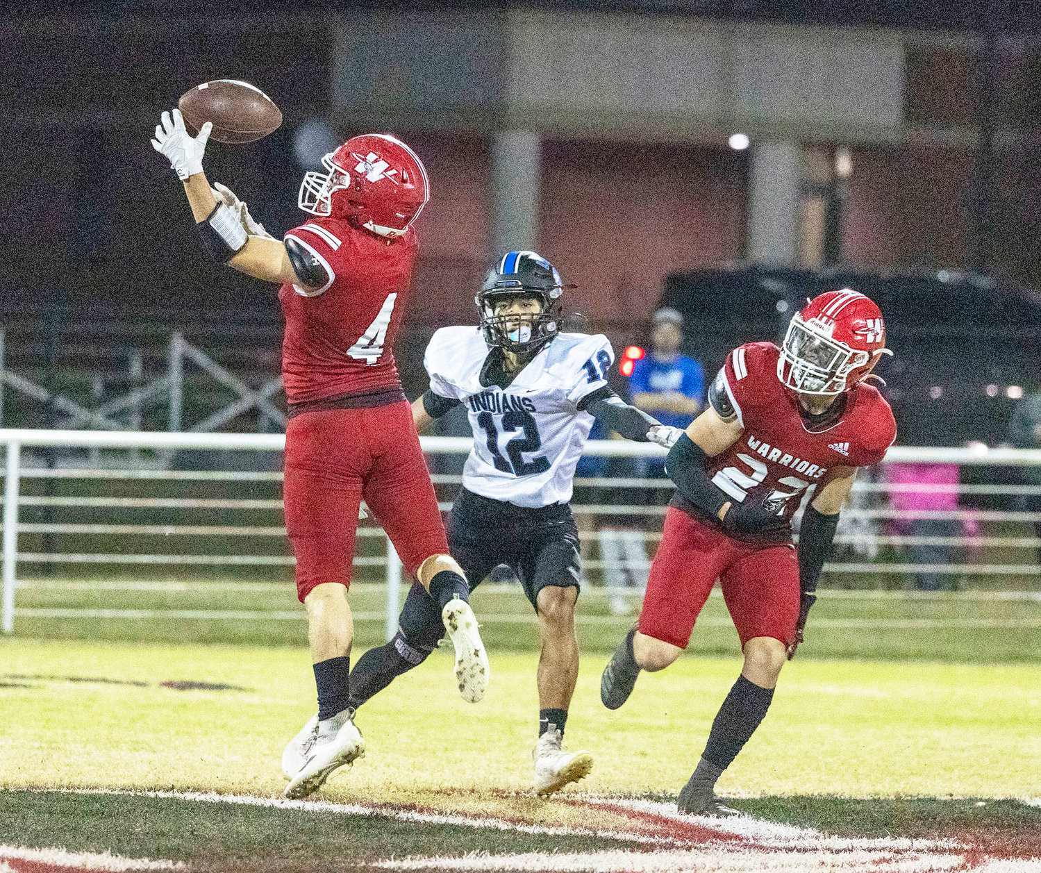 Washington junior Cole Beller (4) tips a ball Thursday night while Marlon Moore (22) provides help during the Warriors’ 47-0 win over Little Axe. The Warriors, 10-0, open the playoffs when they host Atoka Friday.