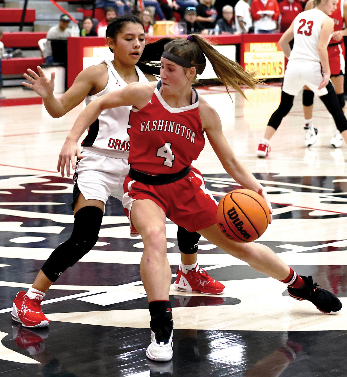 Washington sophomore Rielyn Scheffe dribbles toward the basket against Purcell. The Warriors defeated the Dragons 59-54.