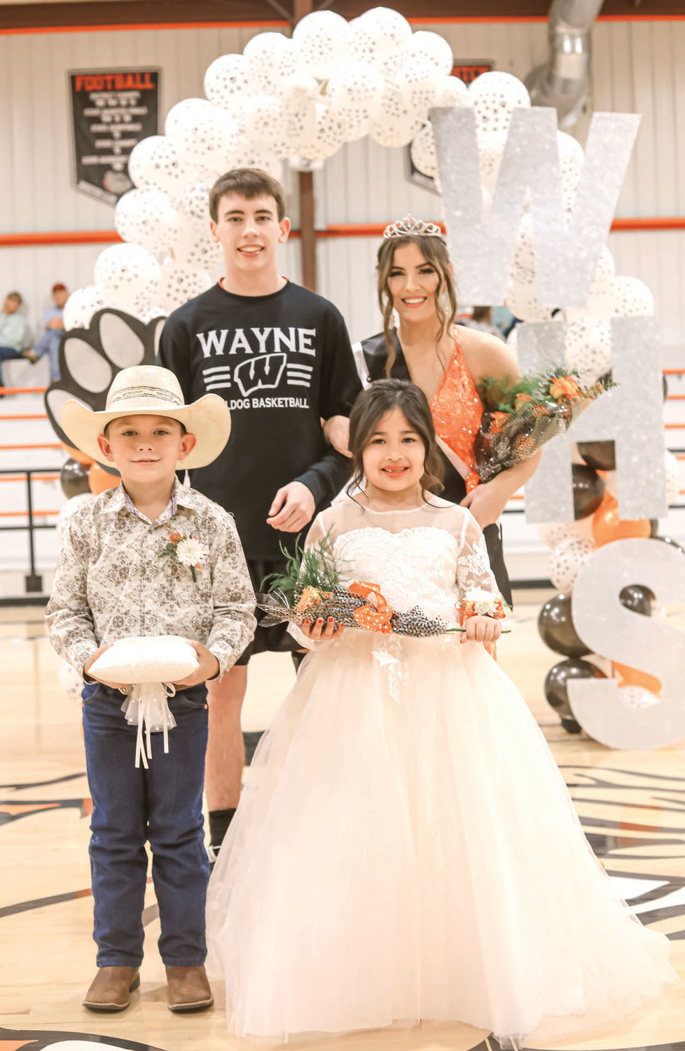 King Kaleb Madden and Queen Kaylee Madden were crowned Homecoming royalty last week at Wayne. They are pictured with crown bearer Laramie Sherwood and flowergirl Andrea Rojas.