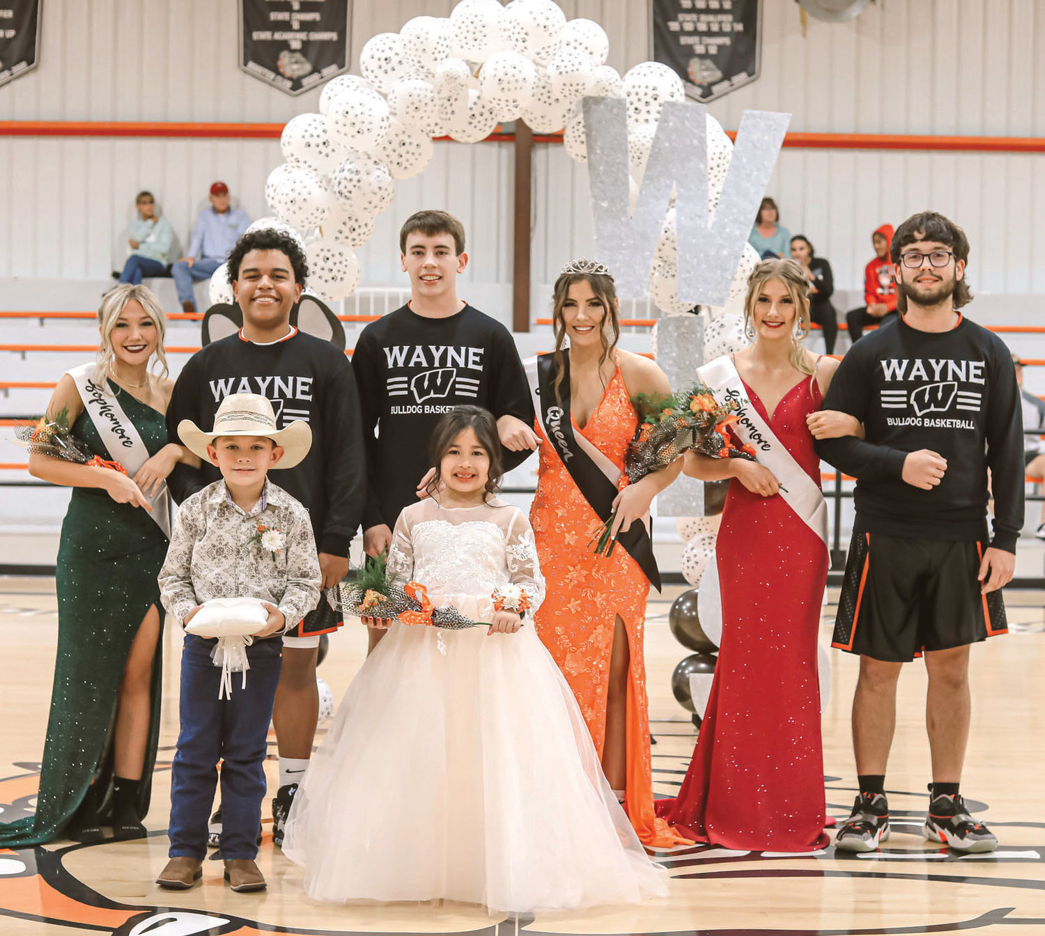 Queen Kaylee Madden and King Kaleb Madden were crowned Homecoming King and Queen last week at Wayne. They are pictured with, from left, Madi Sharp, Taylen Bryant, Kaleb, Kaylee, Addison Keeler and Colton Sweetman. In front are Laramie Sherwood, crown bearer and Andrea Rojas, flower girl.