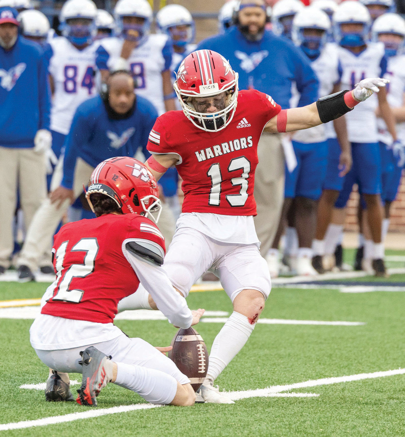 Washington sophomore Mayson Thomas (13) kicks a 25-yard field goal in the Warriors’ 17-14 State championship win over Millwood Saturday. Tatum Wilk (12) was the holder. Thomas was also good on two point after attempts.