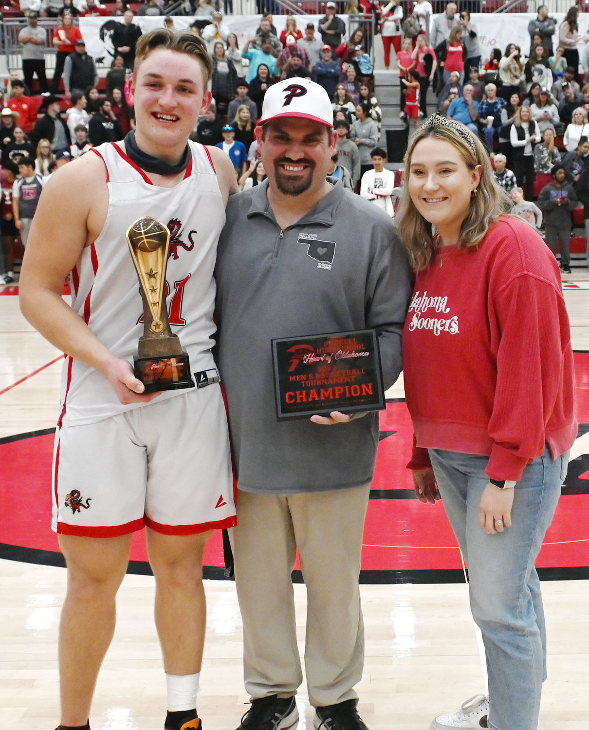 Purcell senior Hayden Ice, left, accepts the Heart of Oklahoma Tournament MVP trophy from Purcell Athletic Director Ricky Hammer (middle) and Elizabeth Robbins with the Jason Bridwell Insurance Agency (right).