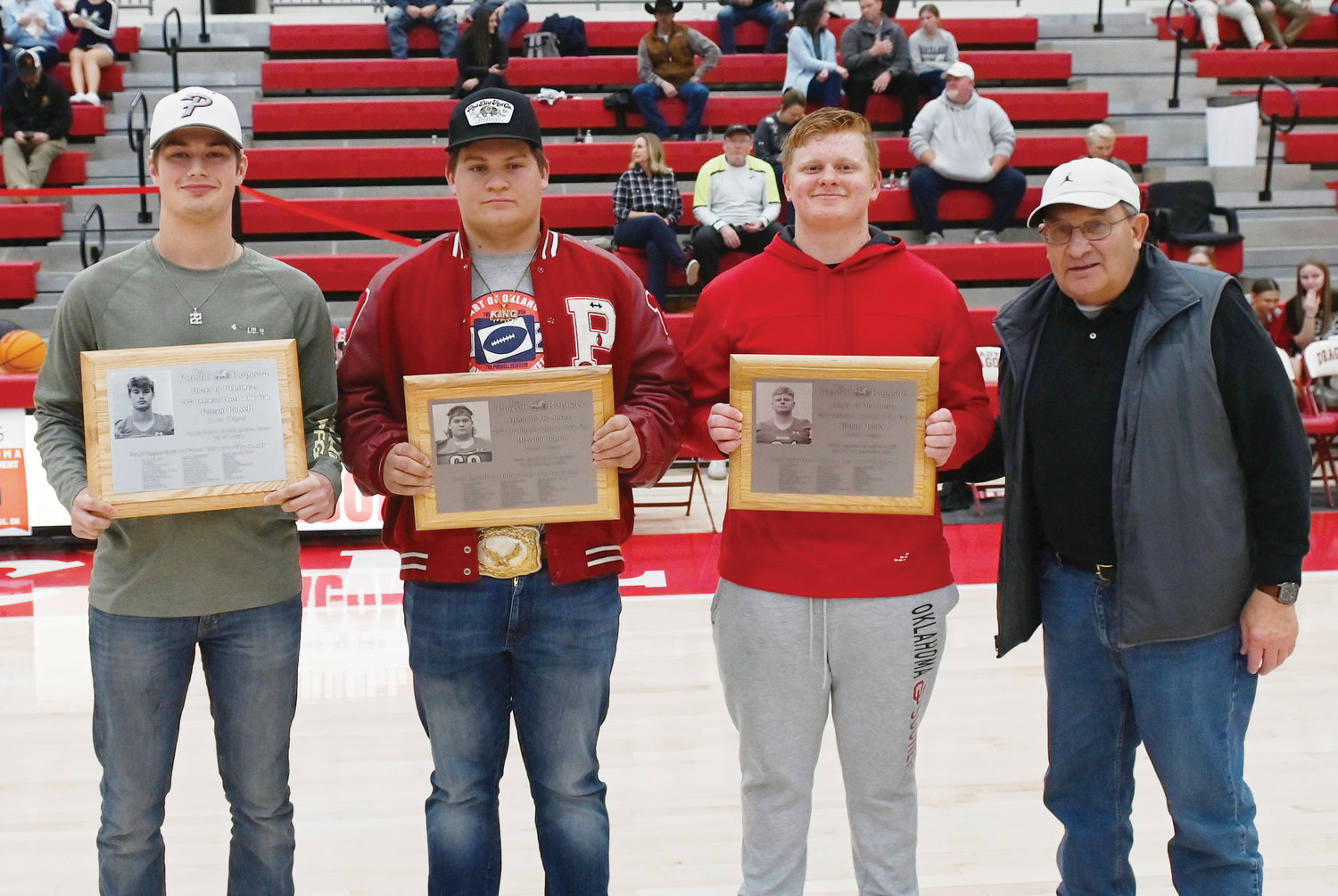 Three Purcell football players were honored as Heart of Oklahoma Player of the year at their respective positions. From left were Payson Purcell – Defensive Player of the Year, Brendon Bacon – Co-Offensive Lineman of the Year and Brody Holder – Defensive Lineman of the Year. Purcell Register publisher John D. Montgomery, far right, presented the awards. Purcell finished the 2022 season with 107 tackles. Bacon graded out at 86 percent blocking for the season. Holder registered 80 tackles in 2022 and had one quarterback sack.
