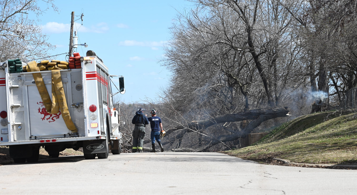 High winds blew a tree onto a power line Tuesday, blocking Monroe Street and sparking a small fire, near 4th Street. Wind gusts were measured in the 50s much of the day.