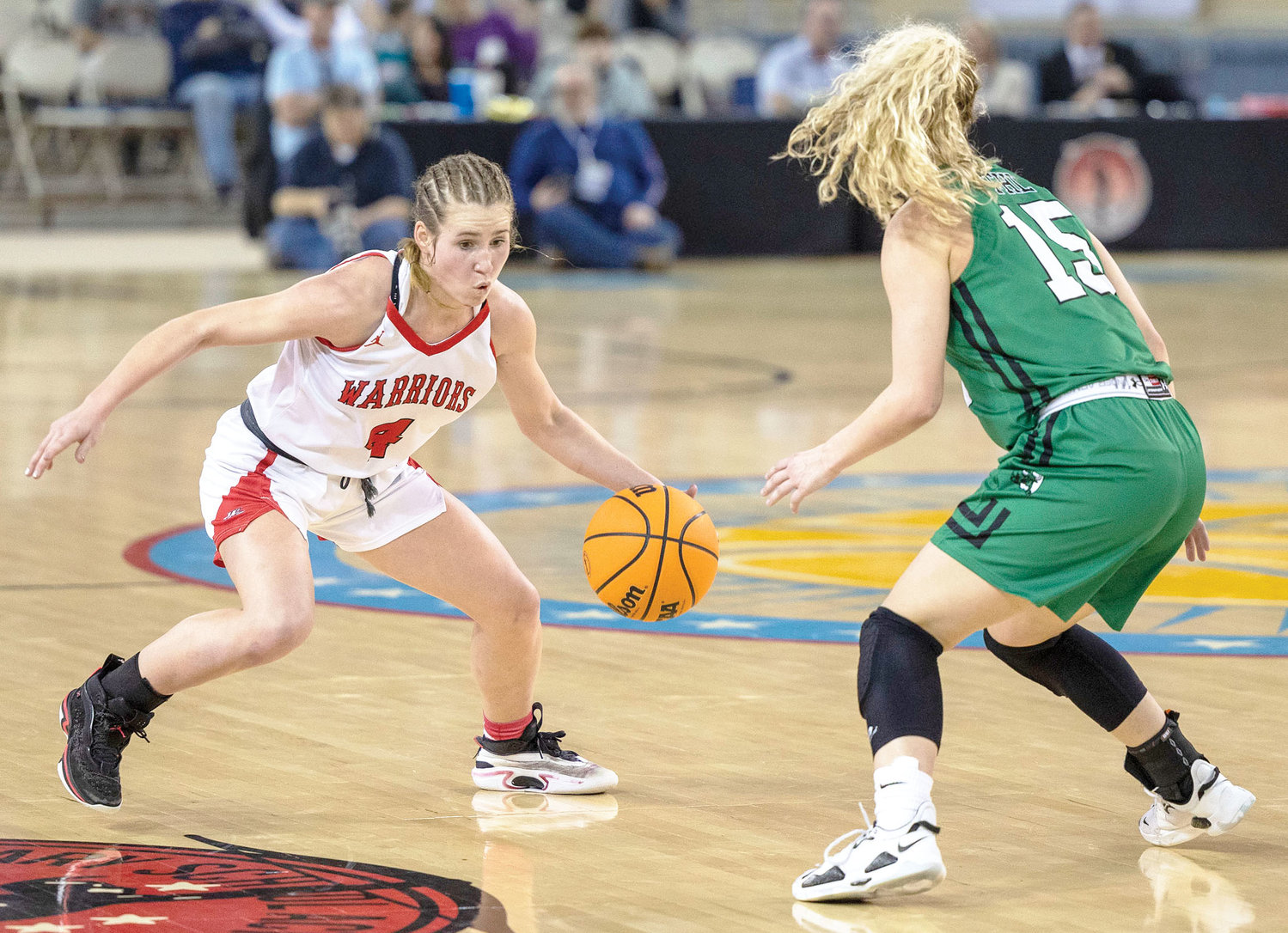 Washington sophomore Rielyn Scheffe puts a move on a defender before driving the ball in during the finals of the State basketball tournament. Jones defeated the Warriors 39-33. Scheffe had a team-high 16 points and was named to the All-Tournament team.