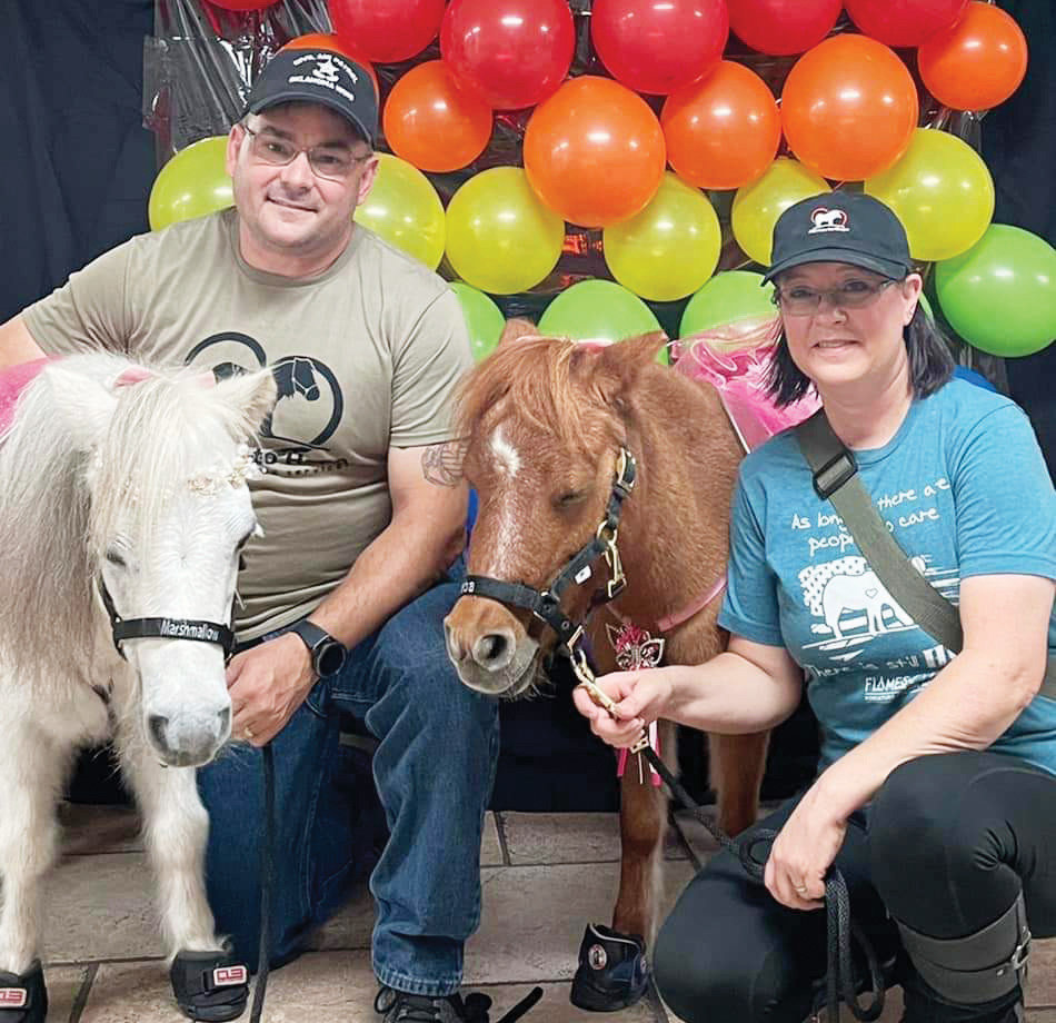 Ron and Kelly King and two of their mini horses, Marshmallow and Reba, that are used as therapeutic healers.