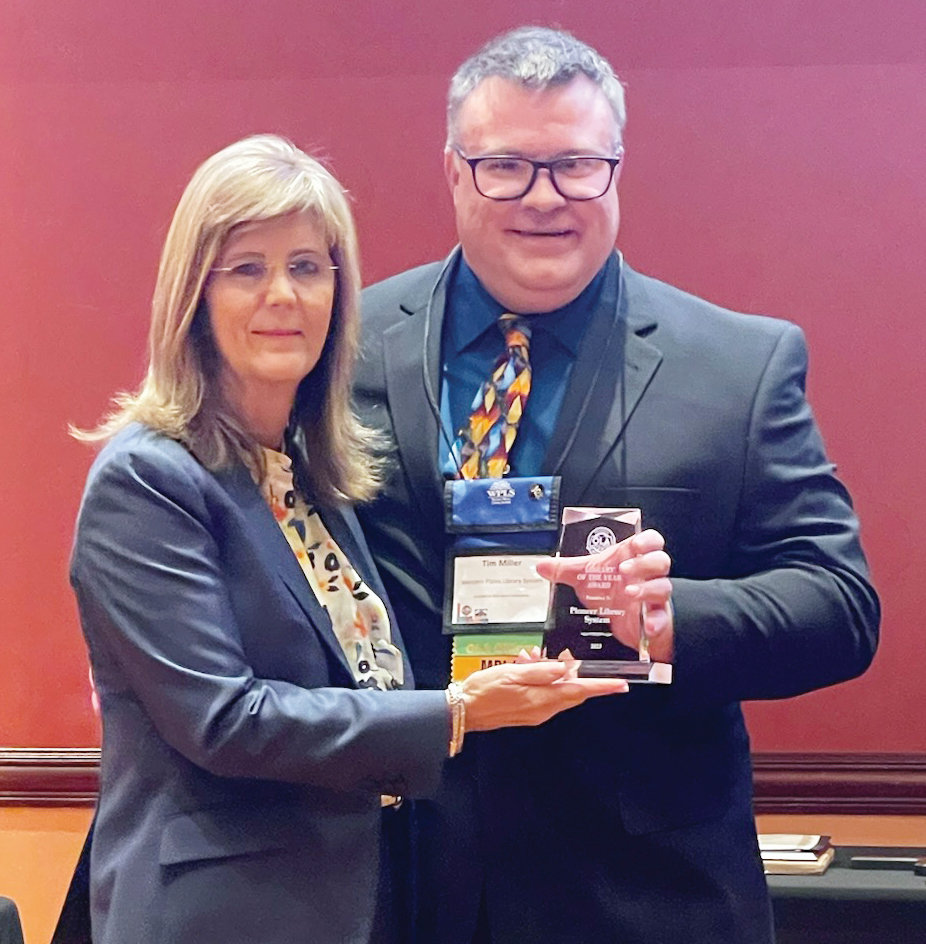 PLS Executive Director Lisa Wells accepted the Library of the Year award from presenter Tim Miller, Executive Director of Western Plains Library System and current Oklahoma Library Association President.