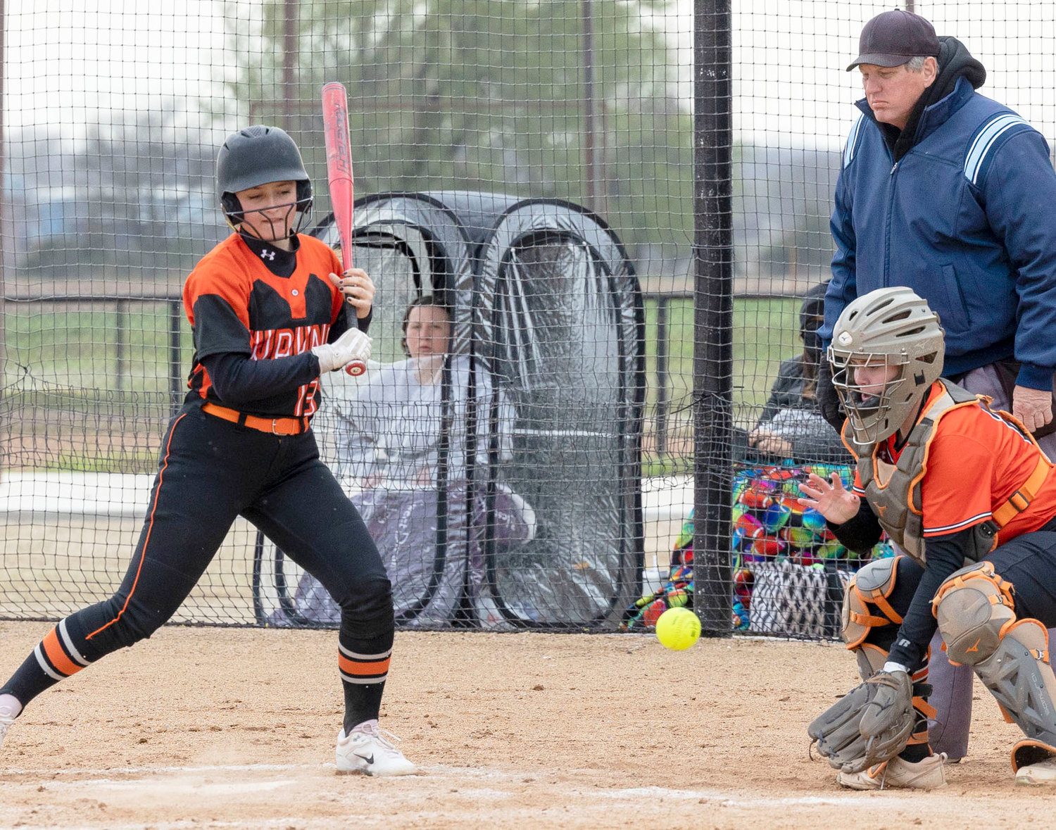 Wayne sophomore Brysten Shephard watches a pitch out of the strike zone during a blustery game Monday. Alex defeated Wayne 16-11.