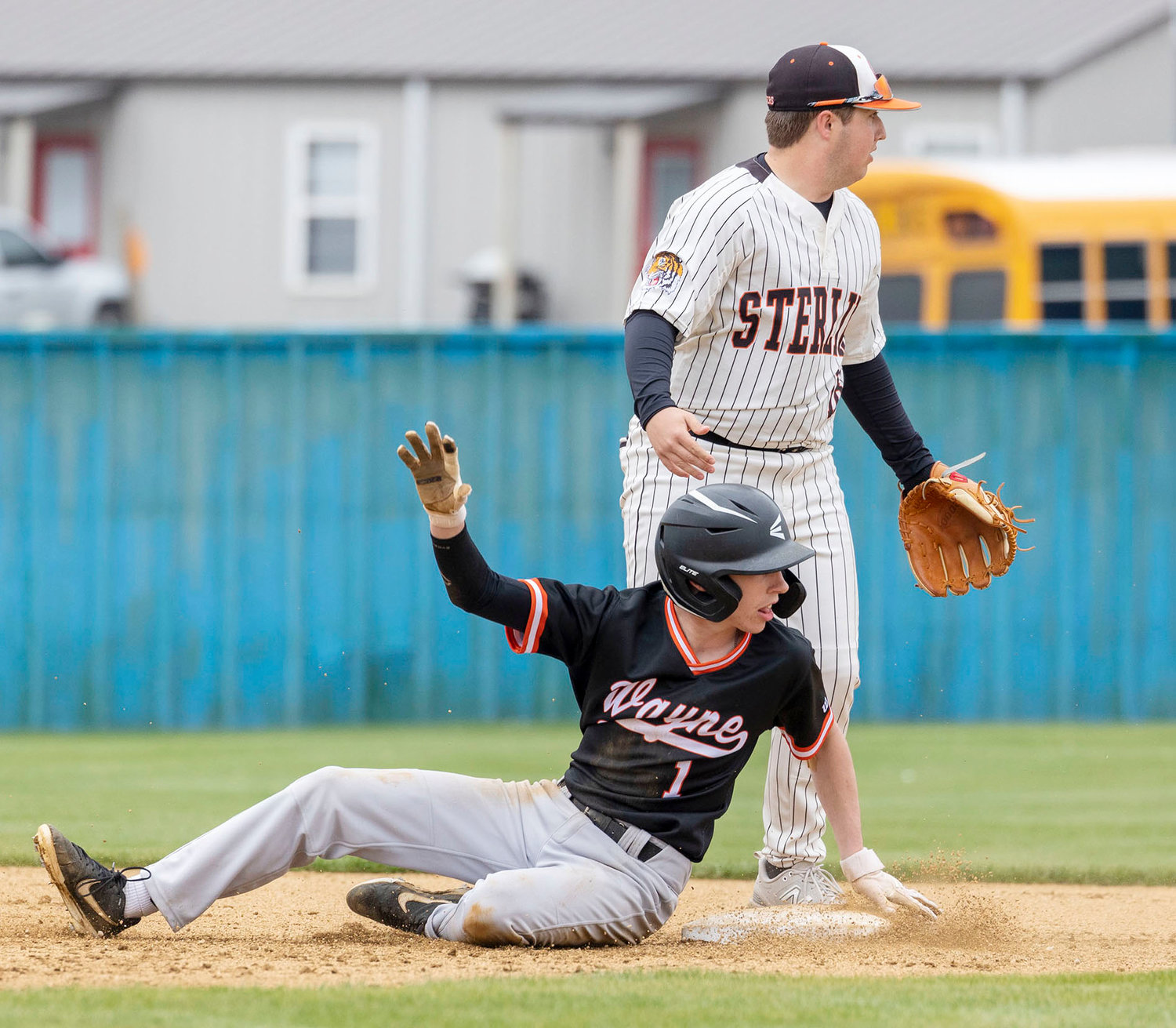 Wayne senior Kaleb Madden slides in safely to second base during the Bulldogs’ game against Sterling at the Dibble tournament. Wayne fell 11-0.