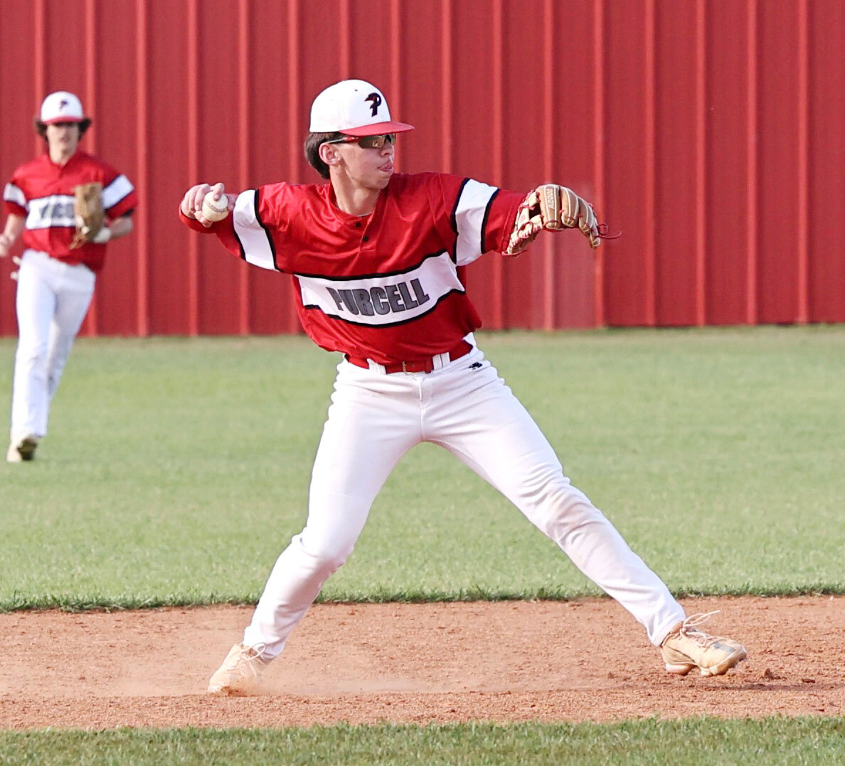 Purcell sophomore Parker Page makes a throw from second base to first for an out during the CHA game. Purcell won 8-7 in 10 innings.