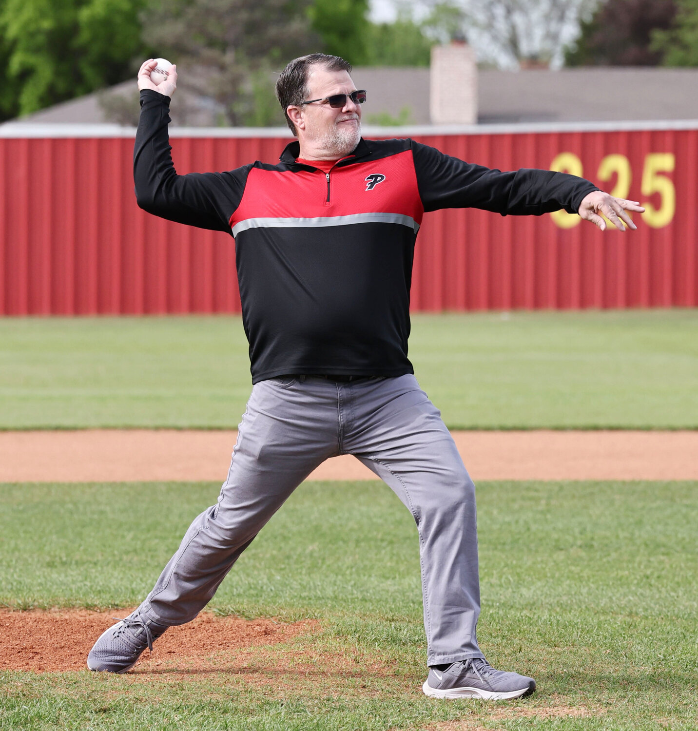 Purcell boys basketball coach Roger Raper threw out the ceremonial first pitch before the Dragons’ game against Ardmore. Purcell won the game 11-5.
