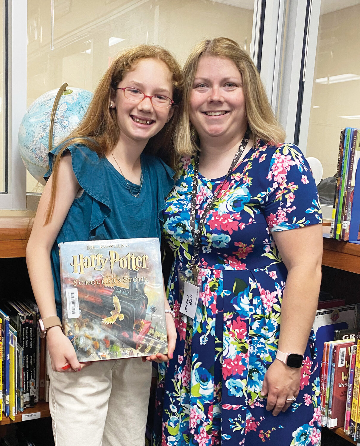 Dibble fifth grader Carlie Hayden broke the school record for amassing 1,148.1 accelerated reading points this year. She was congratulated by Elementary School Librarian Megan Ball.