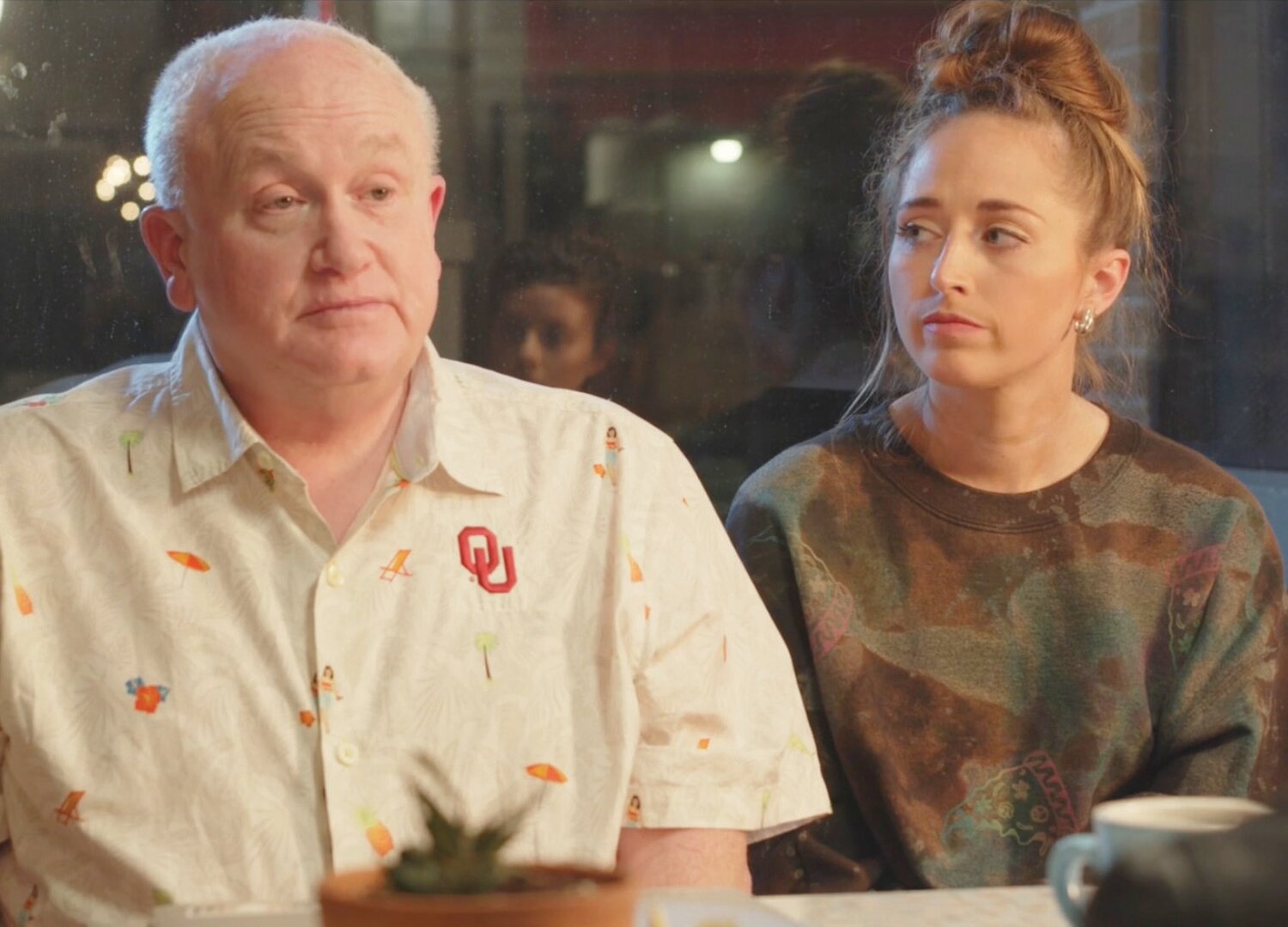 Bud Elder as the character Boomer speaking with his assistant Sara (Paige Kriet) in the movie “Second Chances.”