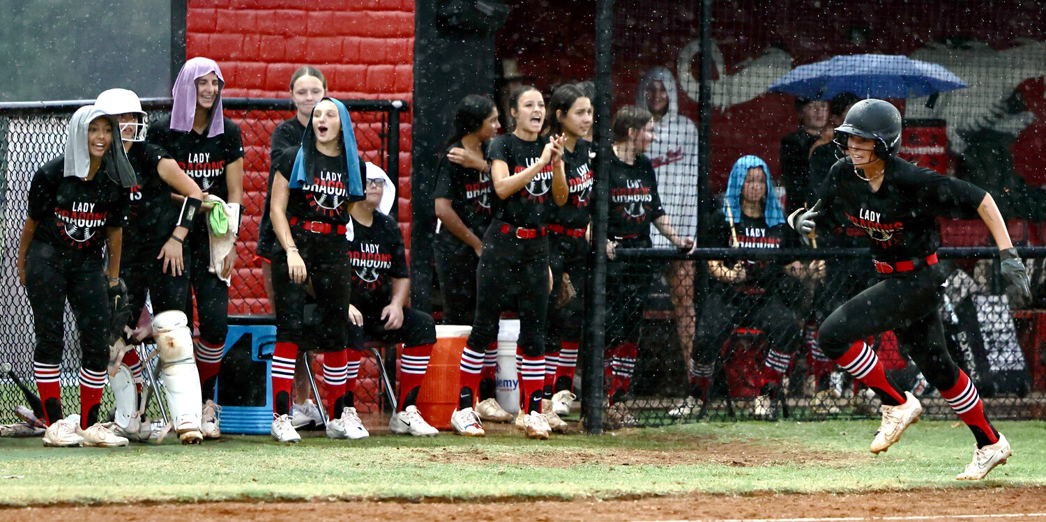 Purcell senior Savanna Edwards scores a run during the Dragons’ 10-0 win over Byng as the rain falls Monday afternoon. Edwards was 1-3 with a pair of RBIs. Purcell is 20-4 this season.