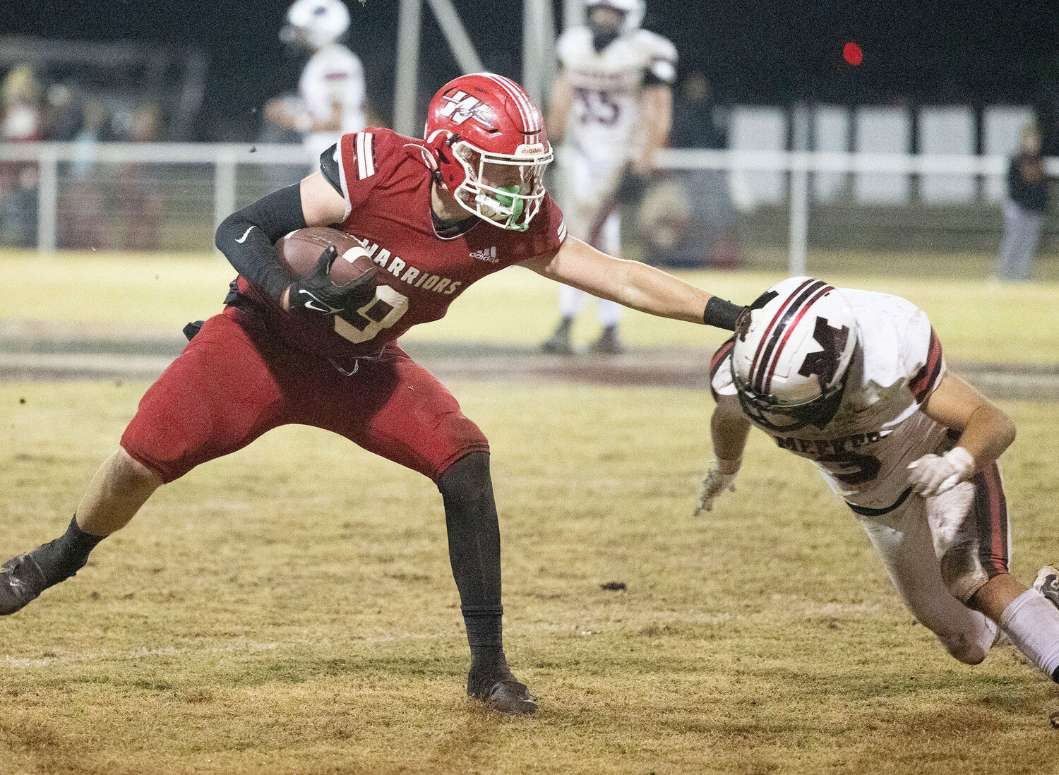 Washington junior Nate Roberts stiff arms a Meeker defender Friday night during the Warriors’ 56-7 win over the Bulldogs. Roberts had two catches for 15 yards.
