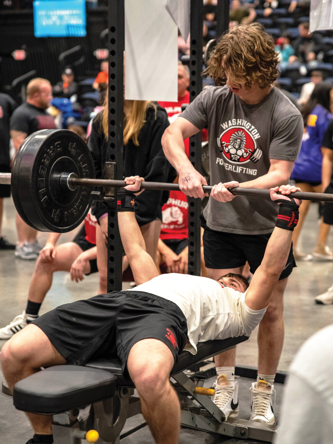 Tanner Olsen spotting teammate Wyatt Wilk at the Bethel Powerlifting meet. Olson was first individually. As a team, Washington finished second.