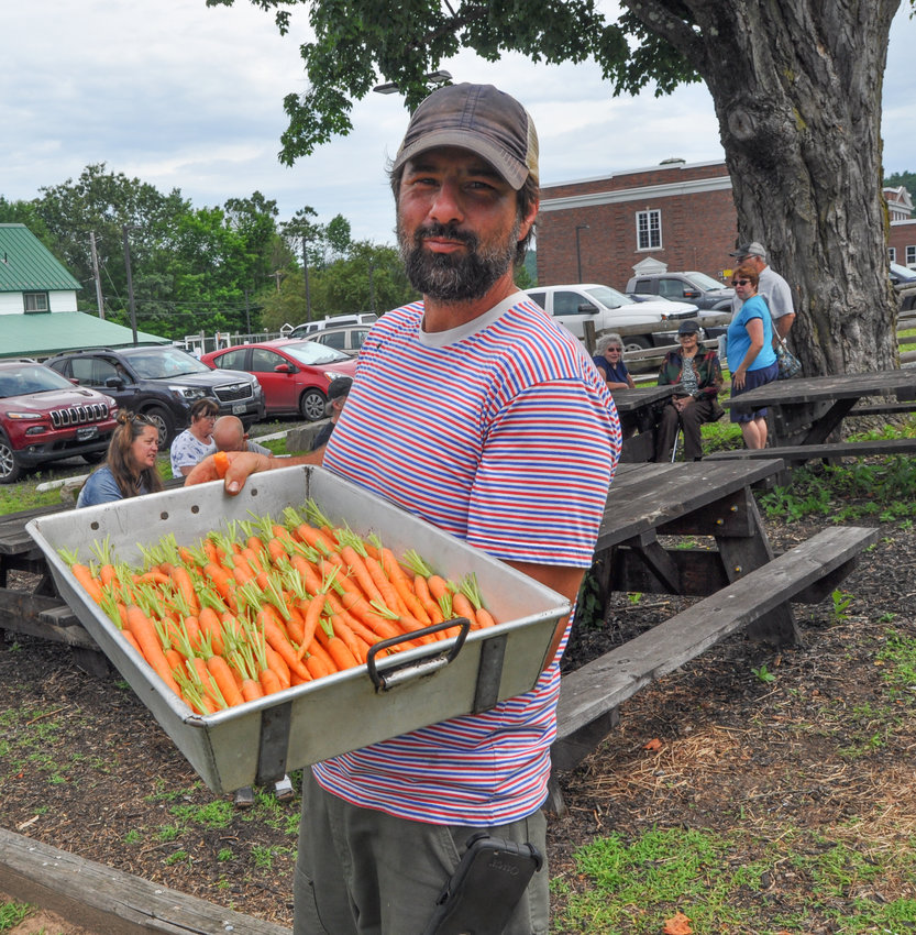 Market Manager Greg Swartz strolled the grounds offering fresh vegetables, as folks shopped the new farmers’ market in Narrowsburg, NY last Saturday morning.