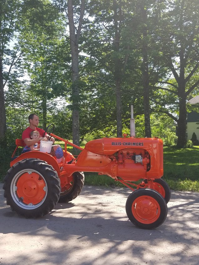 A vintage mid-sized Allis Chalmers rolls by, one of Grandpa’s favorites.
