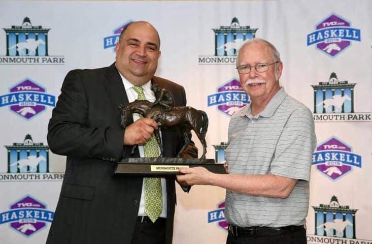 Narrowsburg resident and sportswriter Mike Farrell, right, accepts the prestigious Bill Handleman Memorial Award from Monmouth Park Racetrack announcer Frank Mirahmadi for Farrell’s coverage of the racetrack’s premier race.