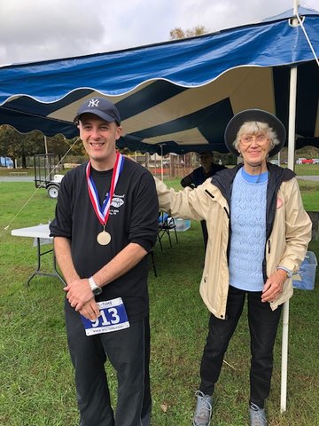 Earning the title of Overall Male Runner in the Hawley Public Library’s Run-To-Read 5K was Walter Pittenger with a time of 22:34. Pittenger, left, is congratulated by Susie George., library board president and event chair.