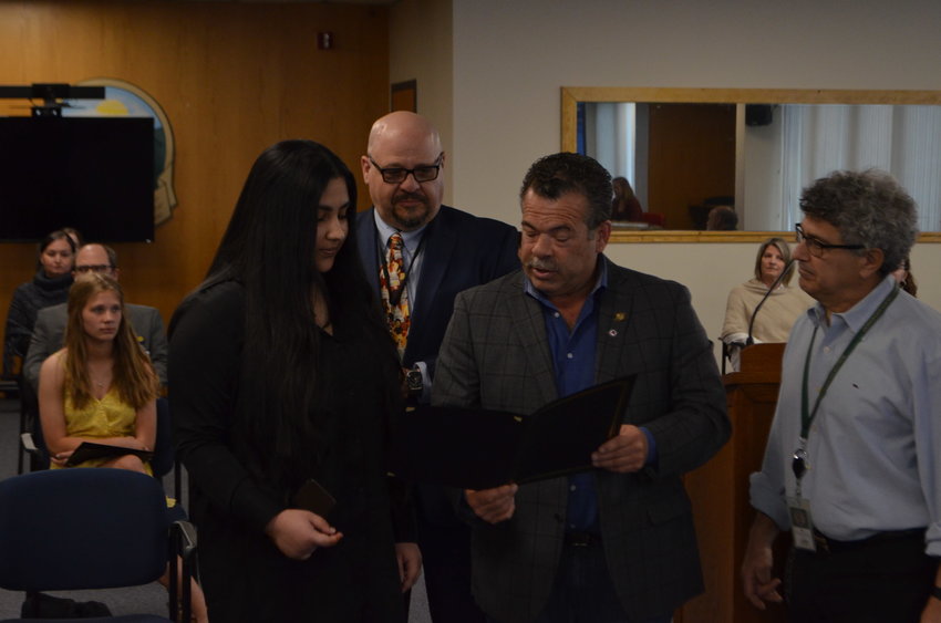 Nabiha Shah Jahan, valedictorian of the Fallsburg Central School District, left, being presented a certificate of honor by legislators Joseph Perello and Ira Steingart, with district superintendent Dr. Ivan Katz in back.