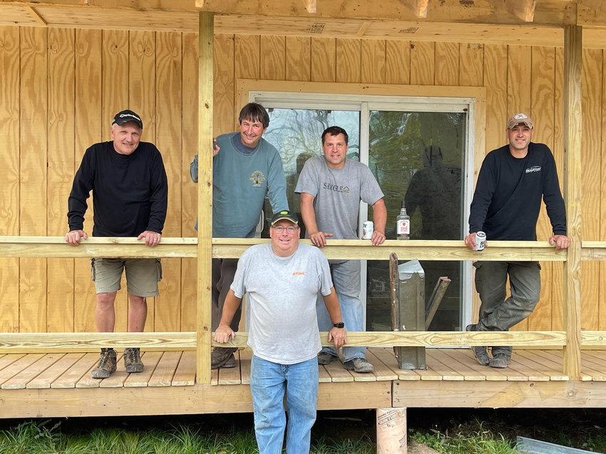 Joe Gombita, left, Jamie Rutherford, Joe Adams, Cody Gilbert and Travis Gilbert were some of the crew members who repurposed the original Fall Music Festival stage into a new cabin’s foundation.