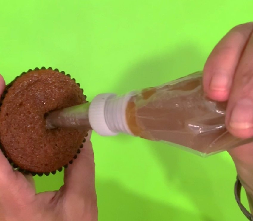 Insert the cupcake filling nozzle tip into a piping bag, and fill the bag with cold honey caramel. Insert tip into cupcake and fill with 1 to 2 tablespoons of caramel.