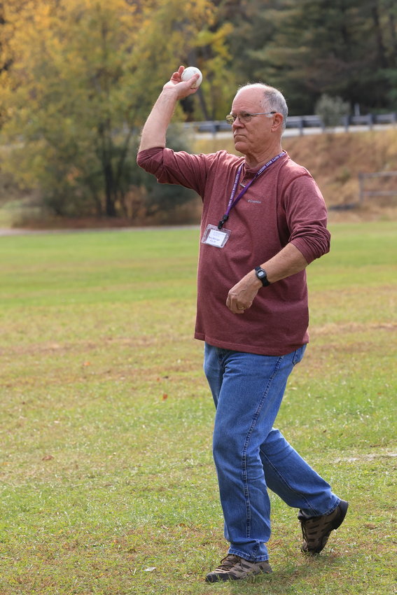 Terry Bollinger, president of Zane Grey’s West Society, tosses the first pitch to begin the exhibition of 1857-era baseball.
