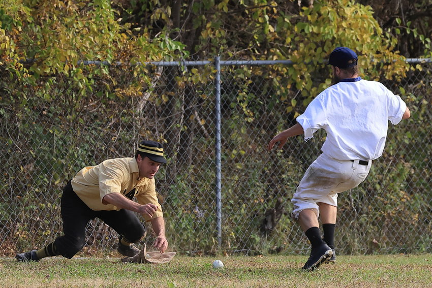 The Mountain Athletic Club third baseman fields the incoming ball ahead of the Delhi runner, thrown by one of the baseman’s teammates to make an out.....
